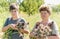 Grandmother with grandson harvested garlic harvest in garden