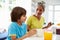 Grandmother And Grandson Having Breakfast Together