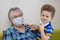 Grandmother and grandson in protective medical masks.