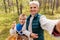 grandmother with grandson taking selfie in forest