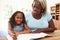 Grandmother Helping Granddaughter With Homework