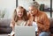 Grandmother helping granddaughter with online studies