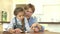 Grandmother Helping Granddaughter With Reading At Home