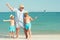 Grandmother with her grandchildren are resting on the sea, they are make a selfie on the beach.