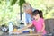 Grandmother and her granddaughter makin an apple pie