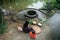 Grandmother and her granddaughter wrapping Chung Cake, the square shape cake, by old well and pond. Traditional Vietnamese New Yea