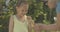 Grandmother holding yellow duckling as happy granddaughter looking at baby bird and smiling. Happy Caucasian girl