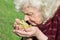 Grandmother holds a lime flower in her hands