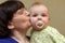 Grandmother kisses baby