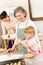 Grandmother with little girl prepare dough