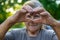 grandmother makes a heart with her hands. Selective focus.