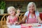 Grandmother making cookies together with granddaughter