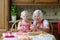 Grandmother making cookies together with granddaughter