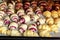 Grandmother making handmade tasty butter rolling cookies with fruit and berry jam on oven tray before baking at kitchen