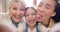 Grandmother, mother and child take a funny selfie as a crazy family in home and bonding together for love. Senior, goofy