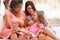 Grandmother,Mother And Granddaughter Sitting Outdoorsï¿½