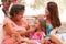 Grandmother,Mother And Granddaughter Sitting Outdoorsï¿½