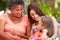 Grandmother,Mother And Granddaughter Sitting Outdoorsï¿½