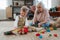 Grandmother playing with her little grandson,building a block set.