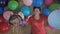 Grandmother plays with her granddaughter in colorful, inflatable balls