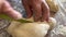 grandmother prepares delicious dumplings or pies or dumplings for her grandson she shakes dough, cuts it into pieces and