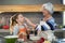 Grandmother putting flour on granddaughters nose