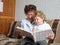 Grandmother reading book to the granddaughter