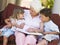 Grandmother reading to grandchildren