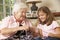 Grandmother Showing Granddaughter How To Knit At Home