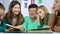 Grandmother showing old photo album to her granddaughters