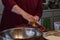 Grandmother shredding zucchini with a cheese grater