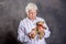 Grandmother with stethoscope is puppet doctor for teddy bear