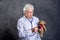 Grandmother with stethoscope is puppet doctor for teddy bear