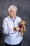 Grandmother with stethoscope is puppet doctor for teddy bear