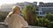 Grandmother in sunglasses stands on the balcony and waves.