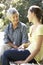 Grandmother Talking With Teenage Granddaughter On Bench