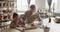 Grandmother teaches her granddaughter to mold clay in pottery workshop