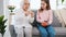 Grandmother teaching granddaughter how to knit