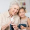 Grandmother teaching her granddaughter to knit