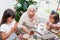 Grandmother teaching her granddaughters how to make christmas Nativity crafts
