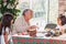 Grandmother teaching her granddaughters how to make christmas Nativity crafts