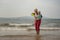 Grandmother and two year old grandson playing in the sea