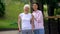 Grandmother with walking frame and young female hugging and smiling at camera