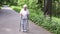 Grandmother walks with Nordic walking sticks old grey