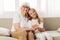 Grandmother woman happy elderly girl family home love sofa old child granddaughter couch