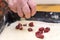 Grandmothers hand preparing cherry pie