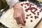 Grandmothers hand preparing cherry pie