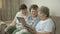 Grandmothers look at photos using digital tablets