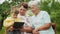 Grandmothers look at a tablet in the hands of a grandson