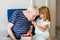 Grandpa And Granddaughter Eating Raspberries At Home. Happy Preschool Girl And Senior Man Having Fun Together. Child And